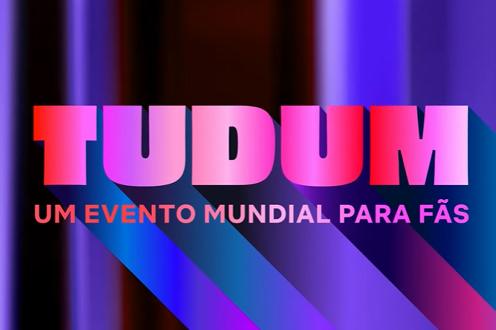 Logo do Tudum: Um Evento Mundial Para Fãs em rosa em um fundo azul e preto