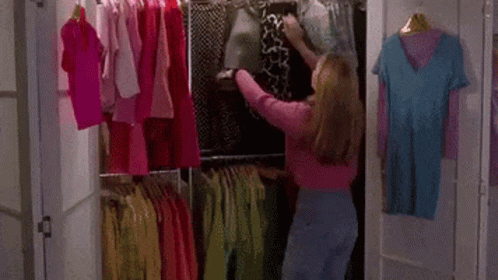 Gif da Cher, de As Patricinhas de Beverly Hills, escolhendo roupas em closet giratório