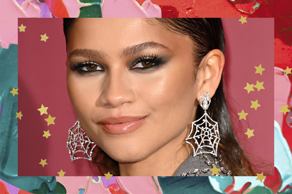 Zendaya at the Spider-Man: No Return Home photocall in London wearing spider-web earrings and smoky black eyeshadow makeup.  The montage has a background with green, red and pink paints and gold stars.