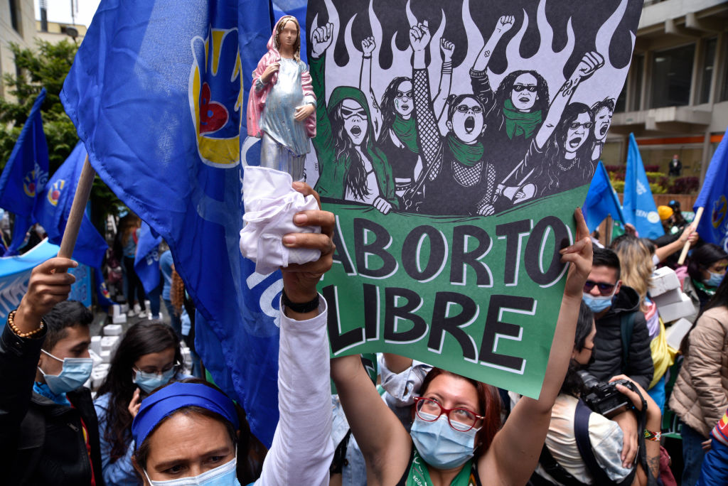 Manifestantes do Movimento Causa Justa celebram a vitória na Corte. Uma glomeração de mulheres seguram cartazes pró-aborto na cor verde.