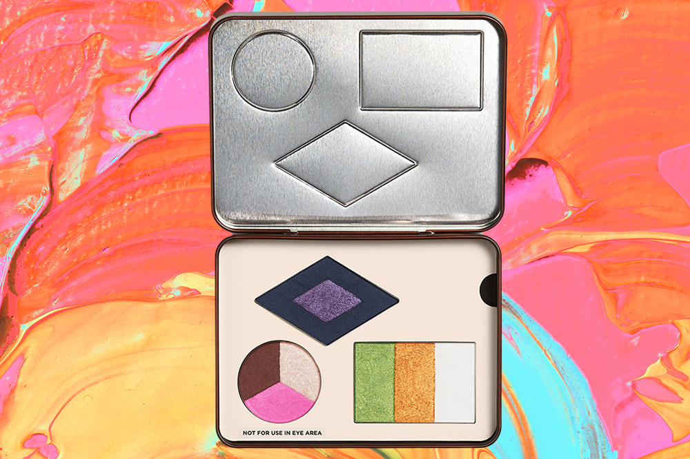 pleasing-harry-styles-marco-ribeiro-paleta-maquiagem A paleta de pigmentos em pó da coleção Pleasing x Marco Ribeiro em fundo laranja, rosa, azul e amarelo