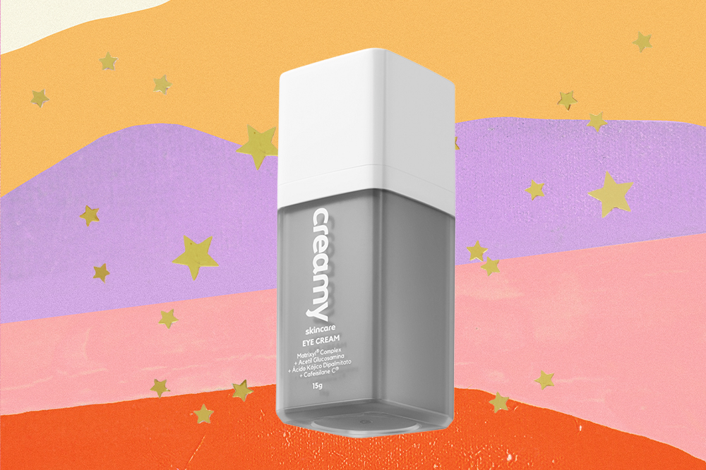 produto-skincare-cada-signo-escorpiao-creme-olhos Creme para olhos em fundo amarelo, lilás, rosa e laranja com estrelinhas douradas