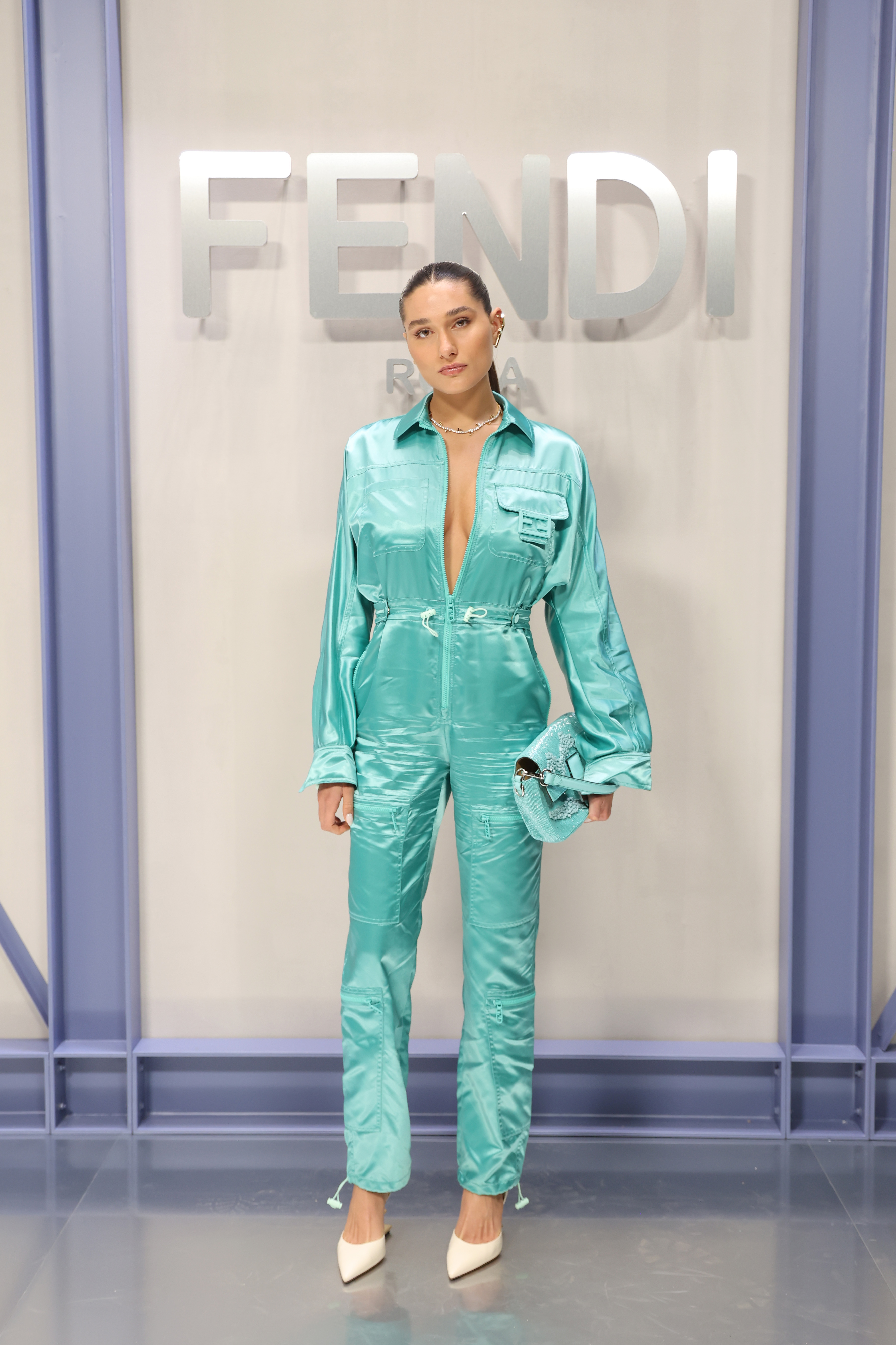 Sasha Meneghel at Fendi's Spring-Summer 2023 show at Milan Fashion Week wearing a turquoise jumpsuit
