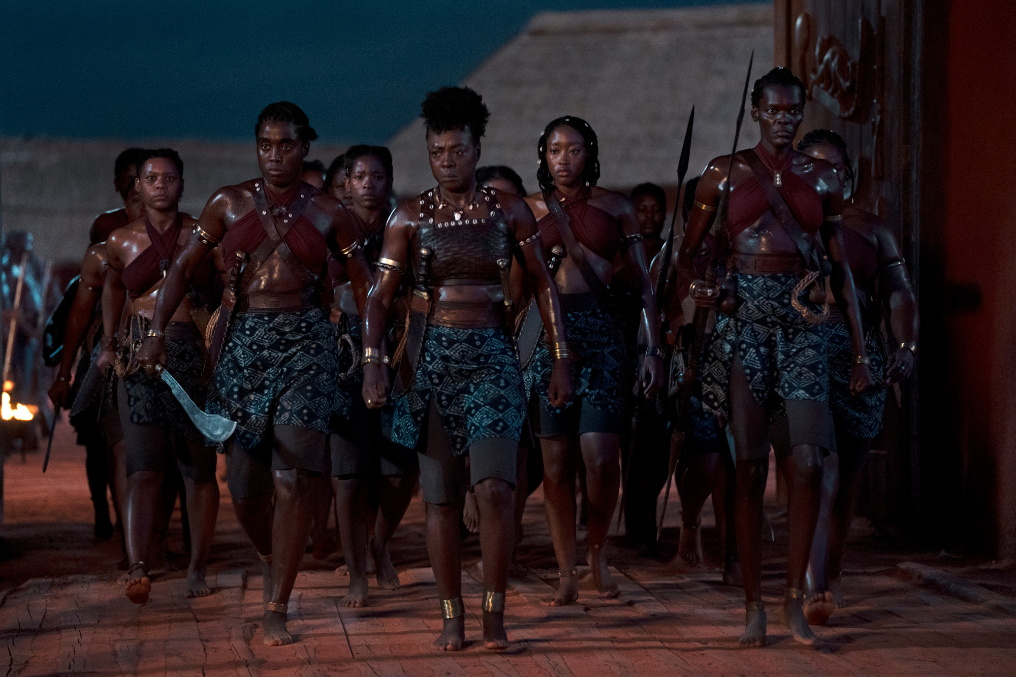 Image shows, in the front row, from left to right, Lashana Lynch as Izogie, Viola Davis as Nanisca, Shelia Atim as Amenza.  In the second row, Sisipho Mbopa, Lone Motsomi and Chioma Umeala as Tara. 