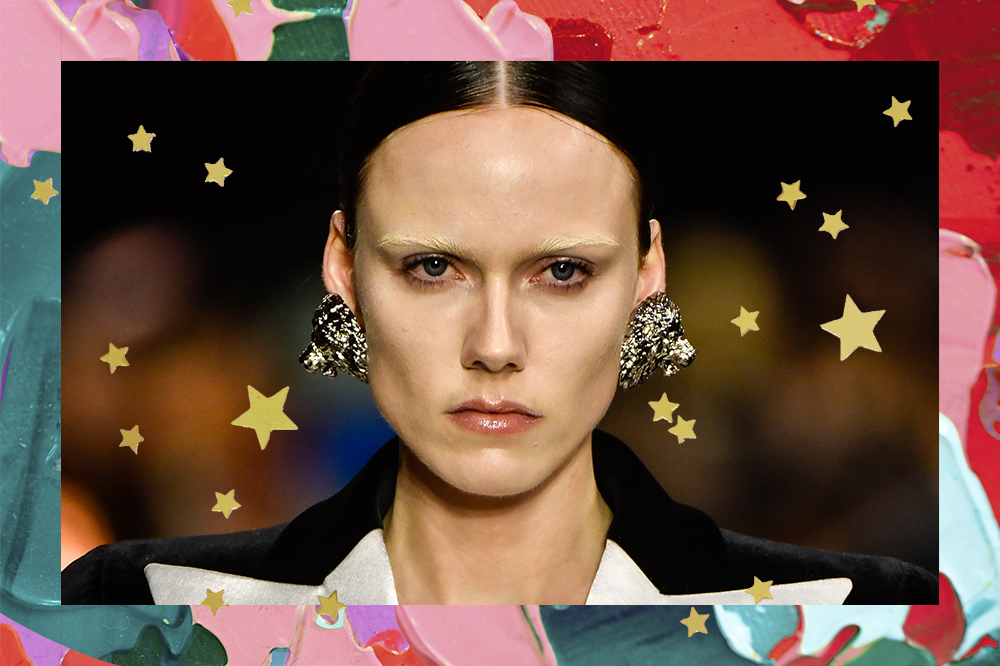 Montagem de modelo com sobrancelhas descoloridas em desfile da Balmain na semana de moda de Paris em fundo de tintas coloridas e estrelinhas douradas