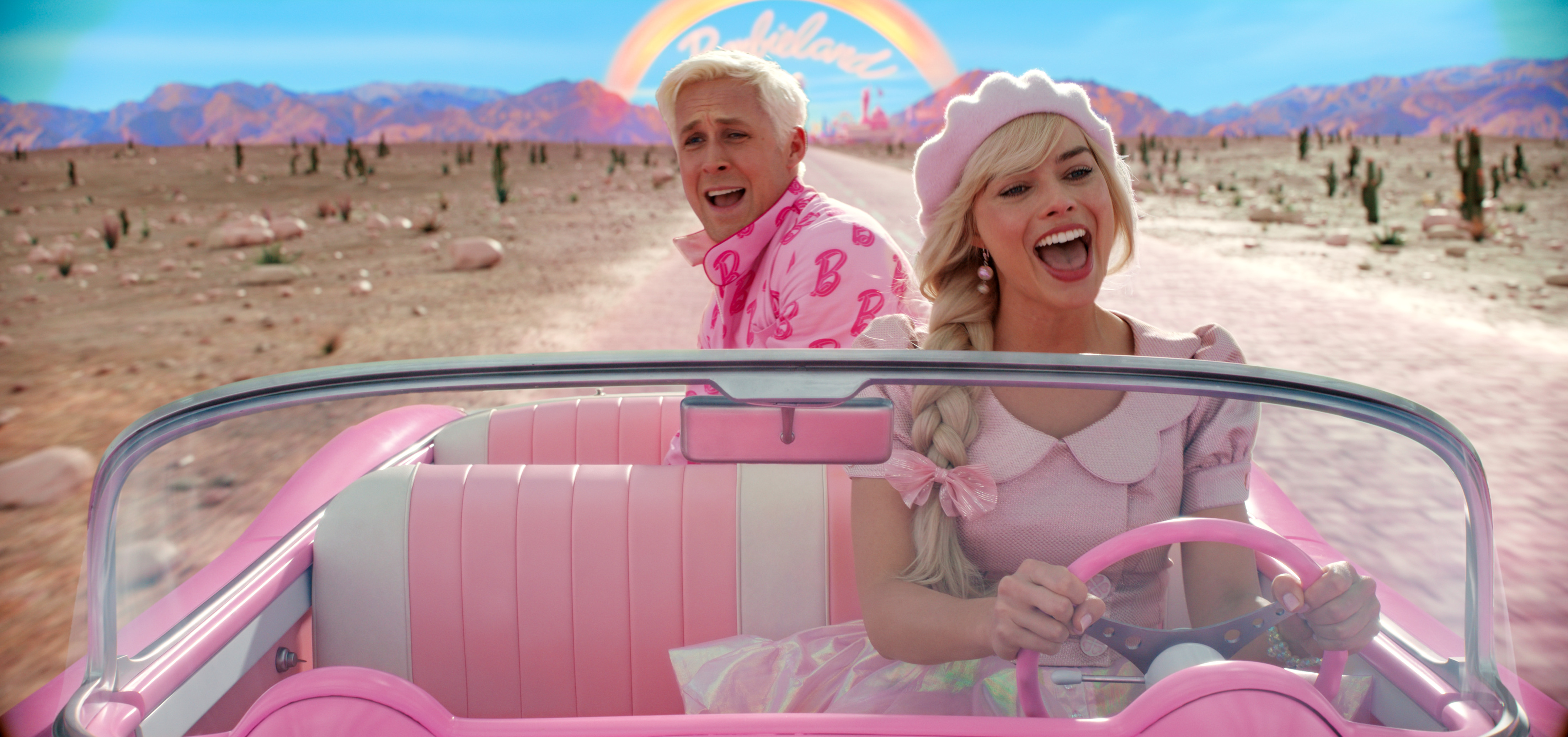 Barbie e Ken cantando no carro rosa com um arco-íris em um céu azul e a Barbieland de fundo