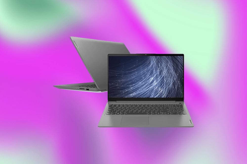 Imagem de um laptop cinza em um fundo roxo e verde claro