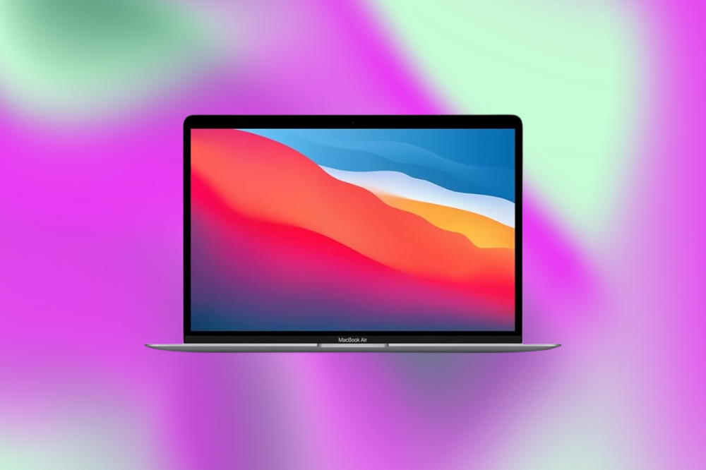 Imagem de um laptop cinza claro em um fundo roxo e verde claro
