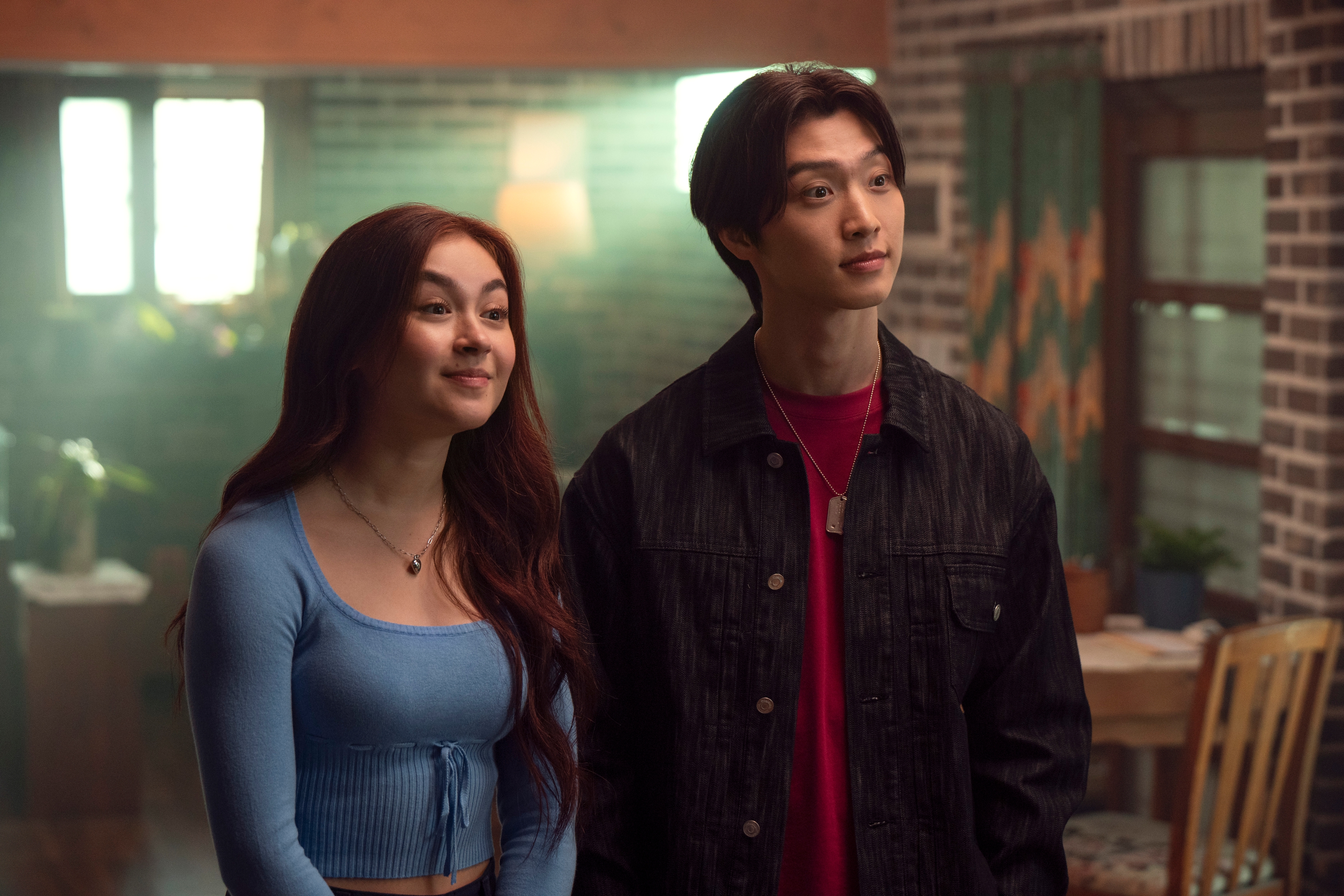 Anna Cathcart como Kitty Song Covey, Sang Heon Lee como Min Ho em Com Carinho, Kitty; eles estão parados e olhando para frente lado a lado
