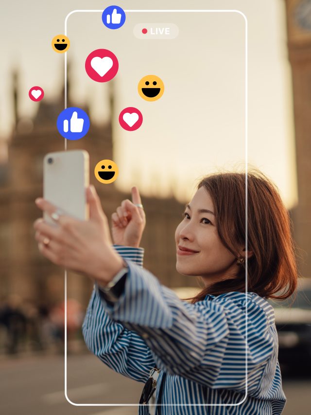 Young female influencer live streaming with smartphone on social media while travelling