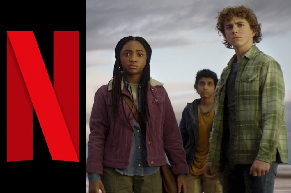 Três jovens, uma garota negra e dois garotos, um indiano e um branco, olham para frente com expressões sérias, em um cenário de céu nublado. À esquerda, o logo vermelho da Netflix em fundo preto. A garota veste jaqueta roxa, o garoto indiano, camiseta amarela e casaco azul, e o garoto branco, camisa xadrez verde