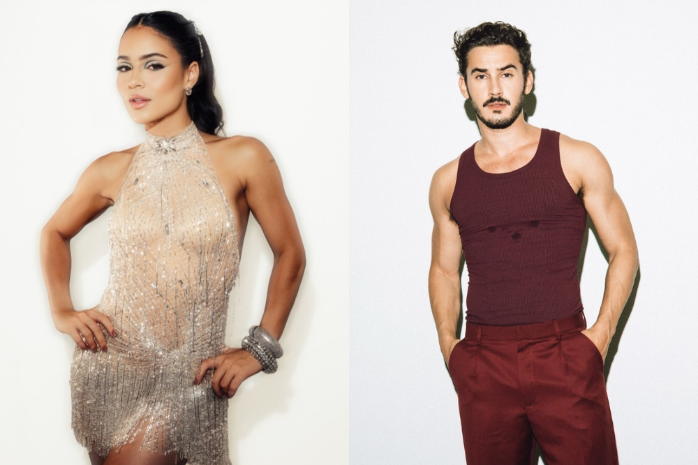 A atriz Christina Milian, com vestido brilhante e prateado, posa ao lado do ator e modelo Matt Pokora, que veste regata e calça vinho, ambos em fundo branco